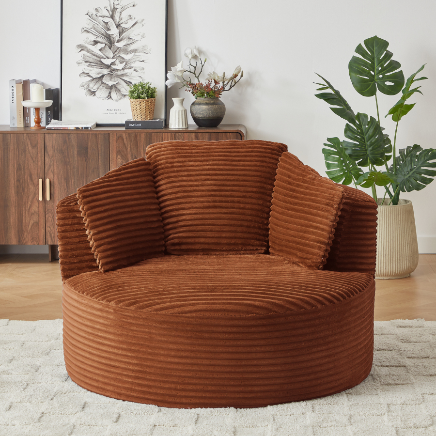 Sillón redondo de pana naranja con asiento profundo